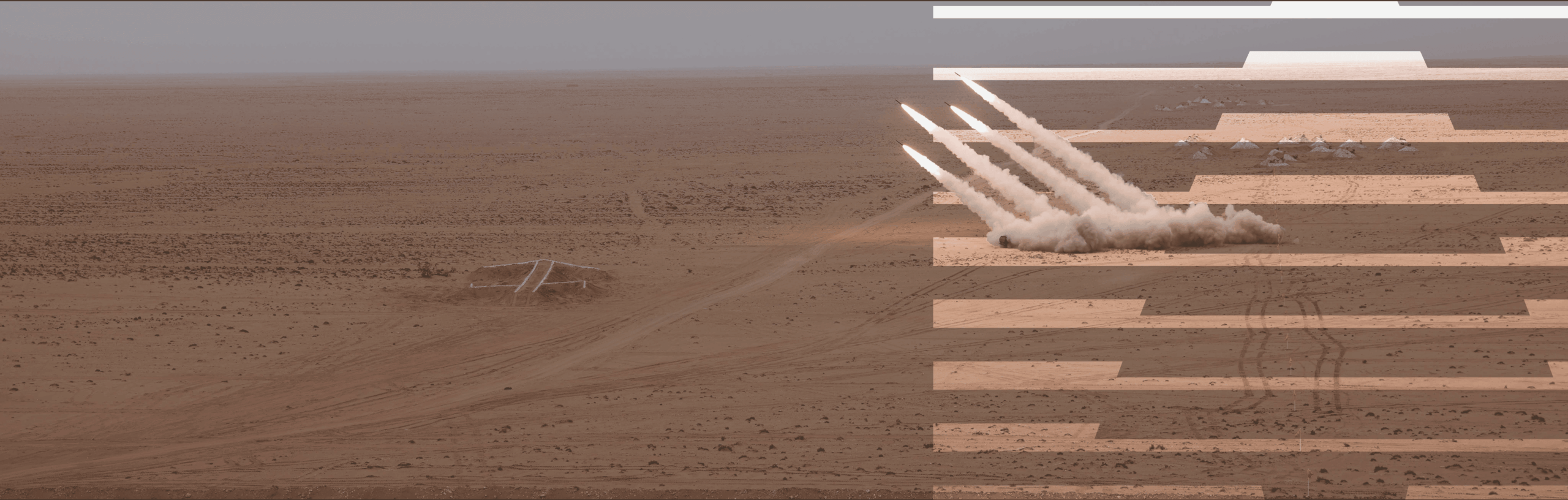 Multiple rockets launching from a desert site.