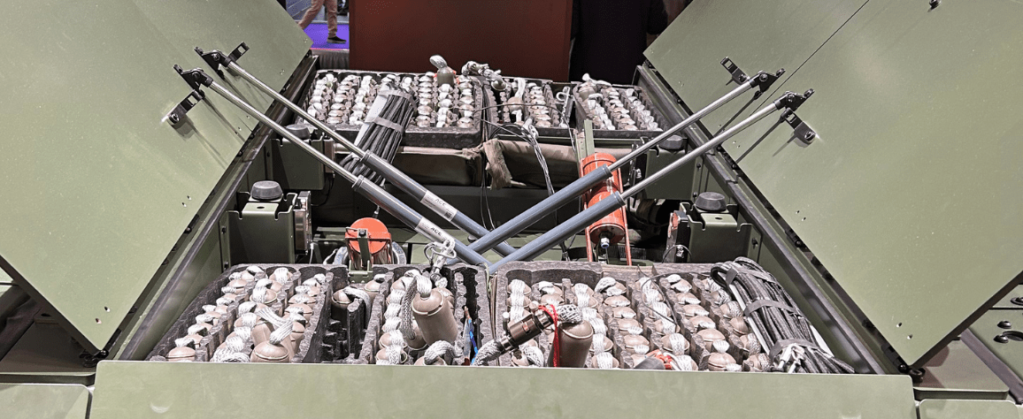 Interior of a military equipment bay filled with organized canisters.