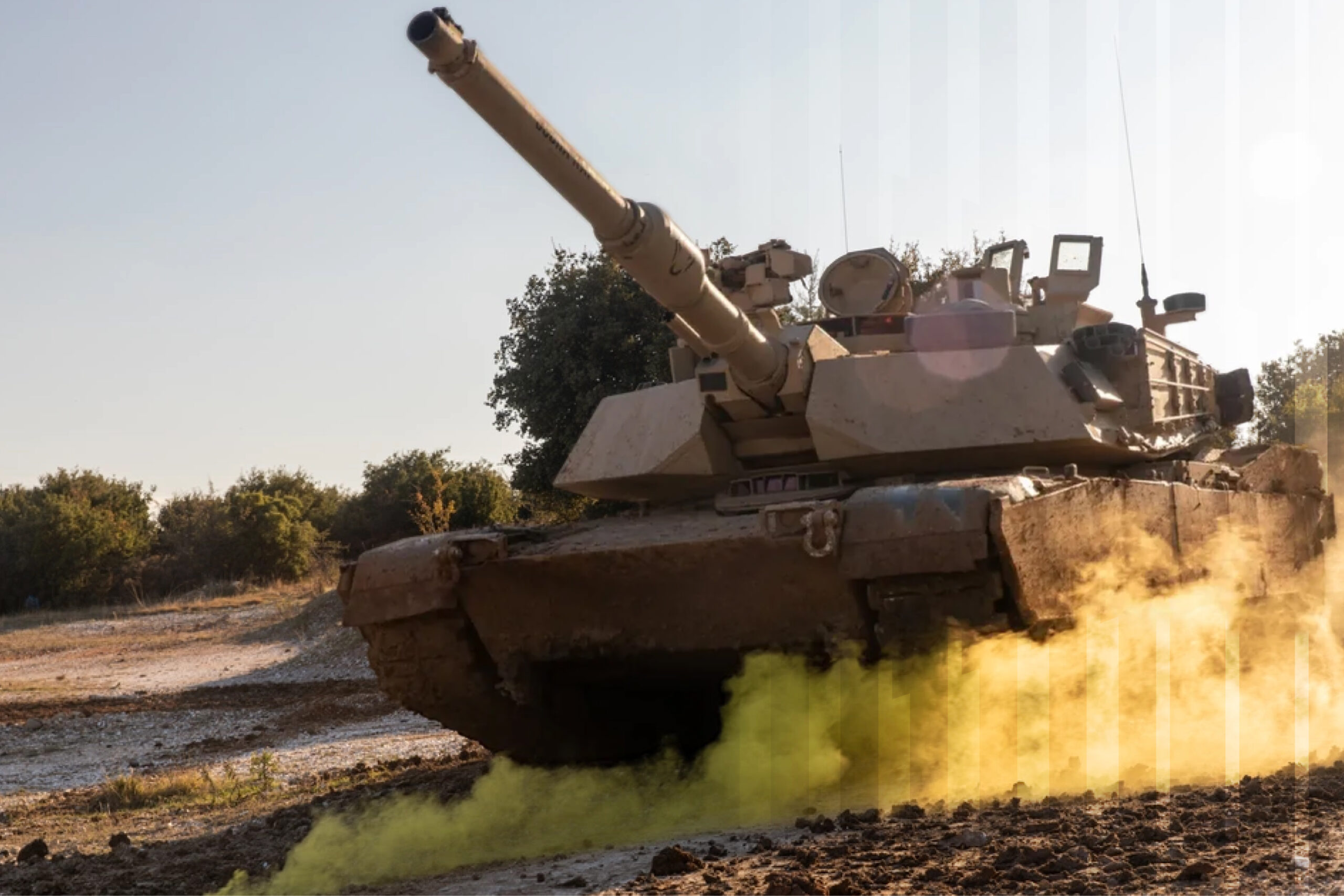 A tan military tank driving across a dirt field, emitting a thick cloud of yellow smoke from its base.
