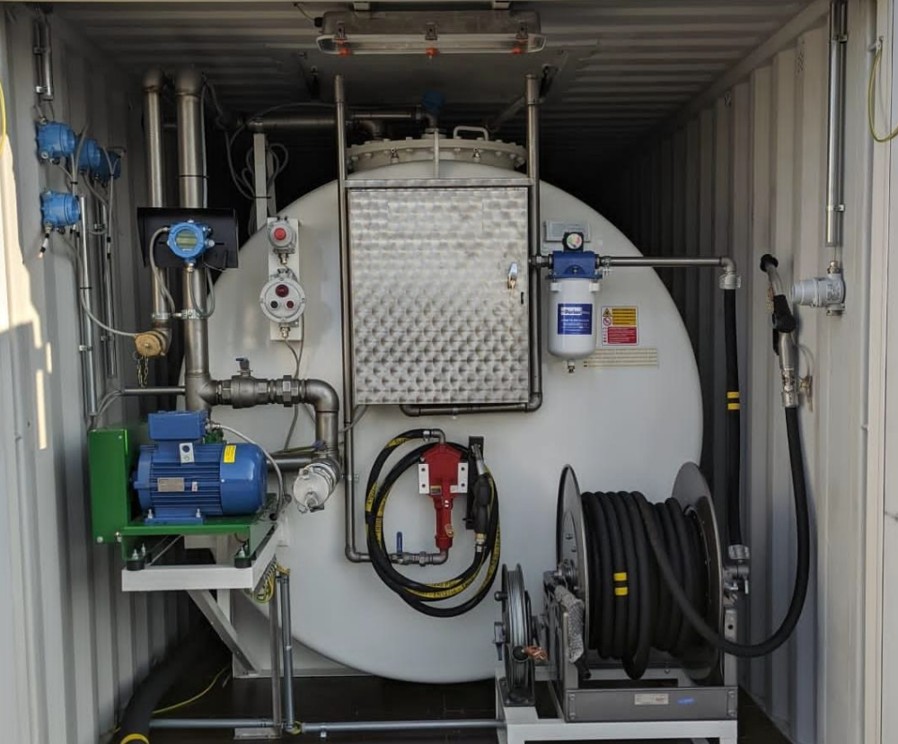 Industrial storage tank and pumping system housed inside a shipping container.